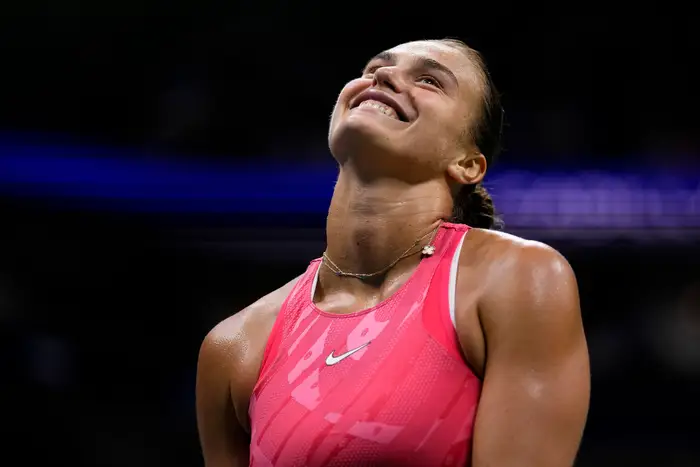 Aryna Sabalenka with a joyful expression after a successful match.