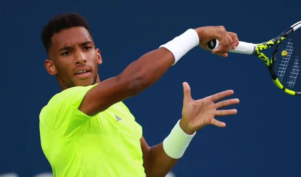 Auger-Aliassime focused on the ball in an intense rally.