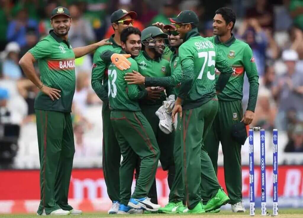 Bangladeshi cricket team players celebrating a wicket.