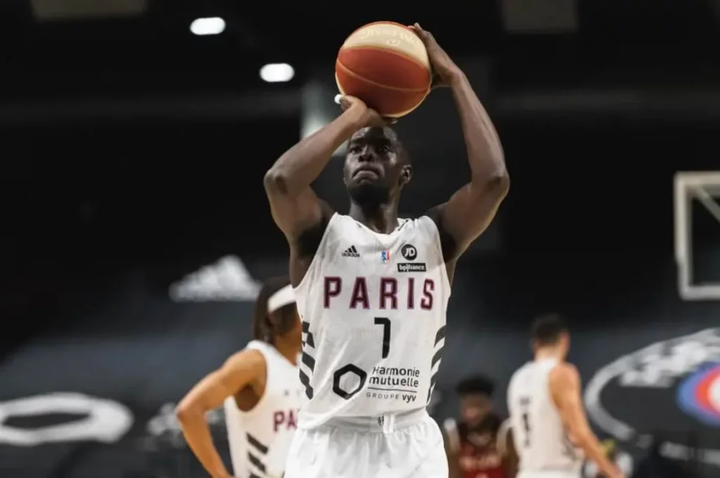 Paris basketball team player in action on the court.