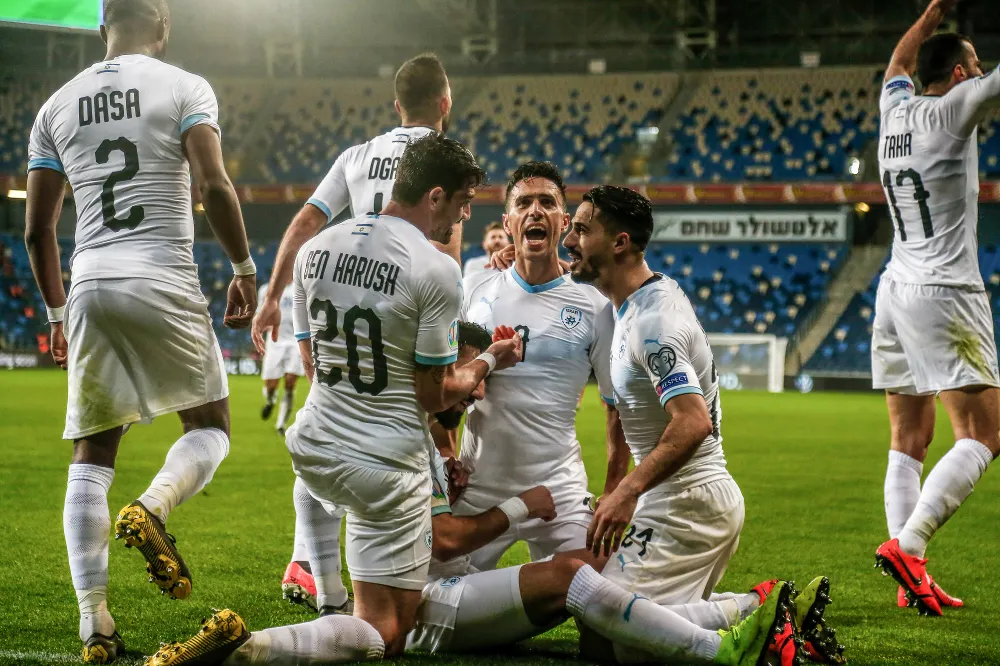 Israeli players celebrate a goal in the Euro 2020 qualifier at Sammy Ofer Stadium.