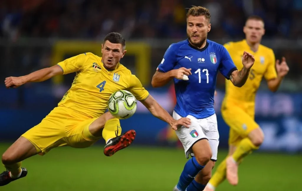 Italy and Ukraine national team players vying for ball control.