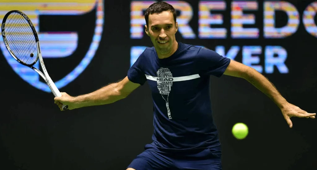 Mikhail Kukushkin on the court, showing his forehand technique.