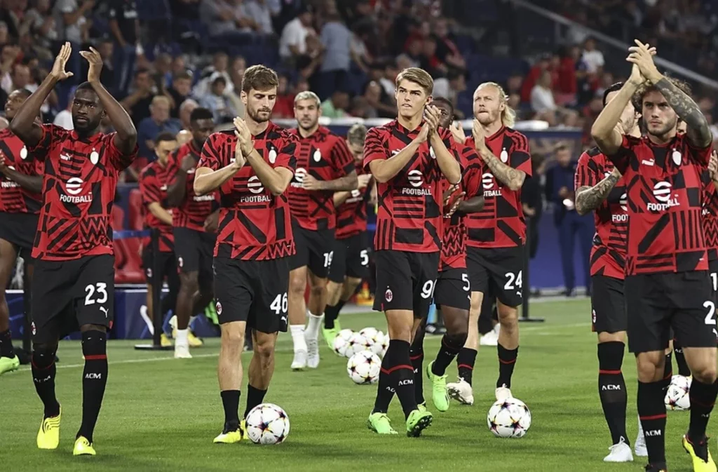 Rossoneri players in their iconic red and black stripes kit.