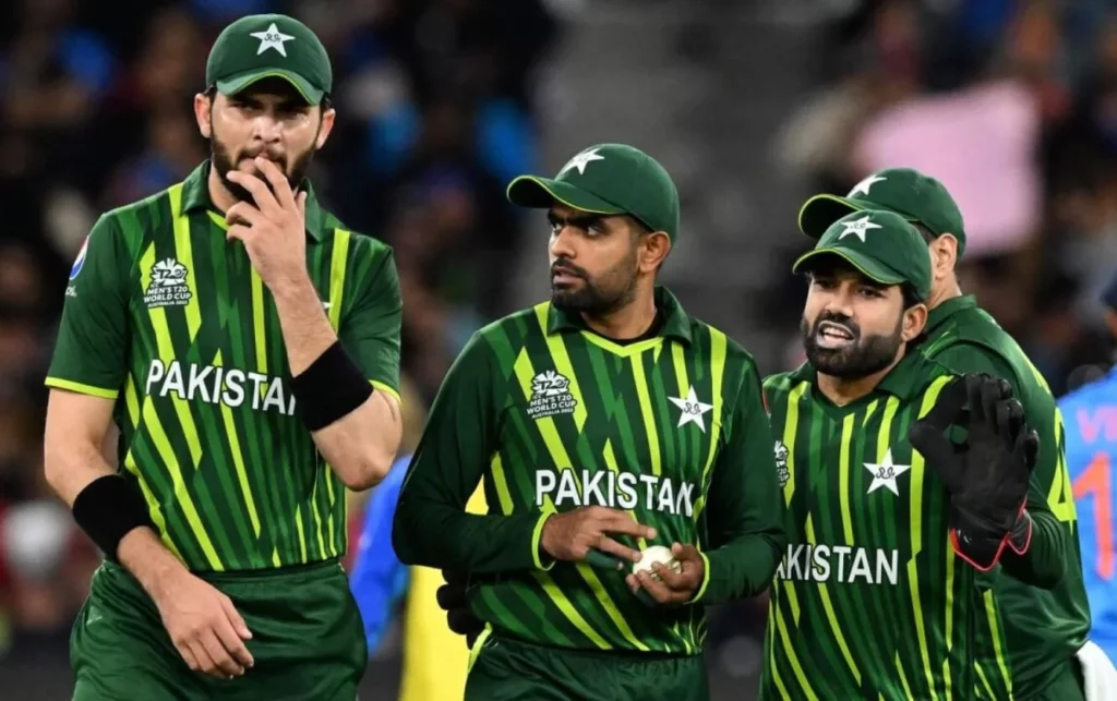 Pakistan team members in a jubilant huddle post-match.