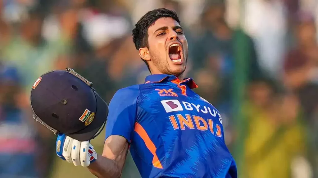 Shubman Gill dressed in India's blue cricket jersey.