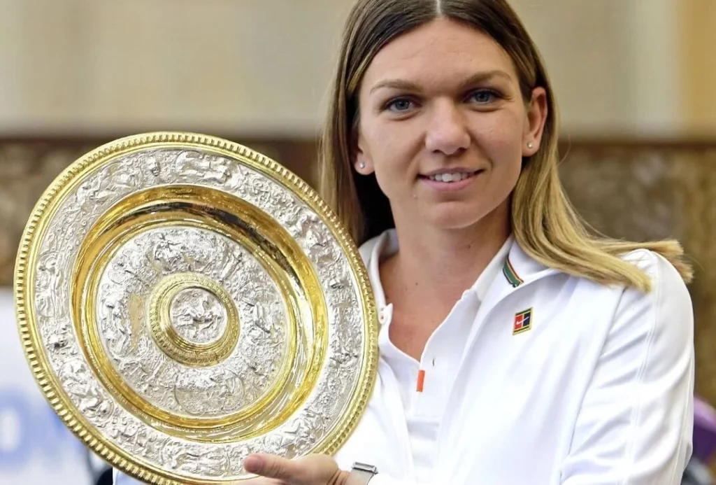 Simona Halep proudly holding the Wimbledon trophy.