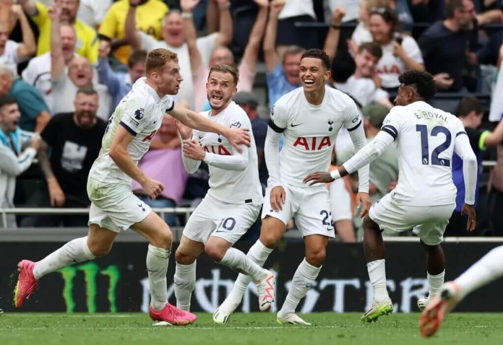 Tottenham Hotspur players celebrating a goal on the pitch.