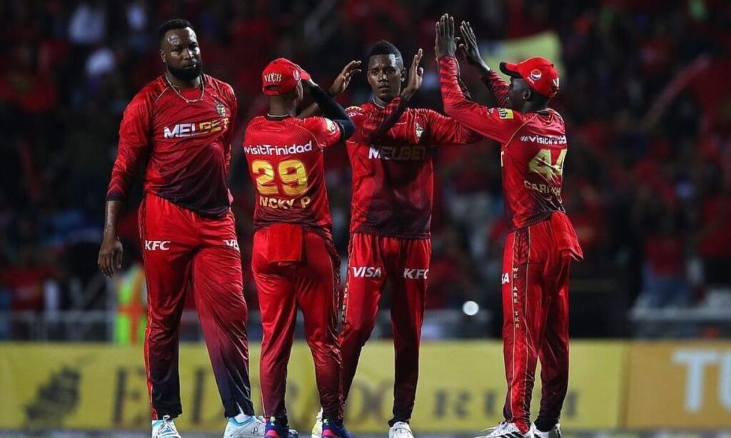 Trinbago Knight Riders team members celebrating on the pitch.