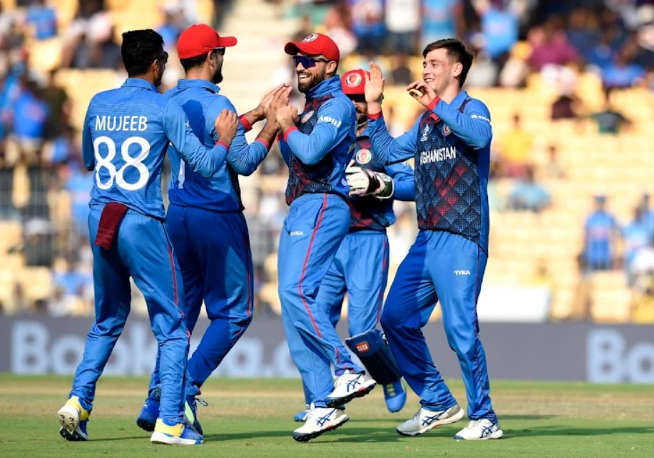 Athletes of Afghanistan's cricket team in mid-game focus.