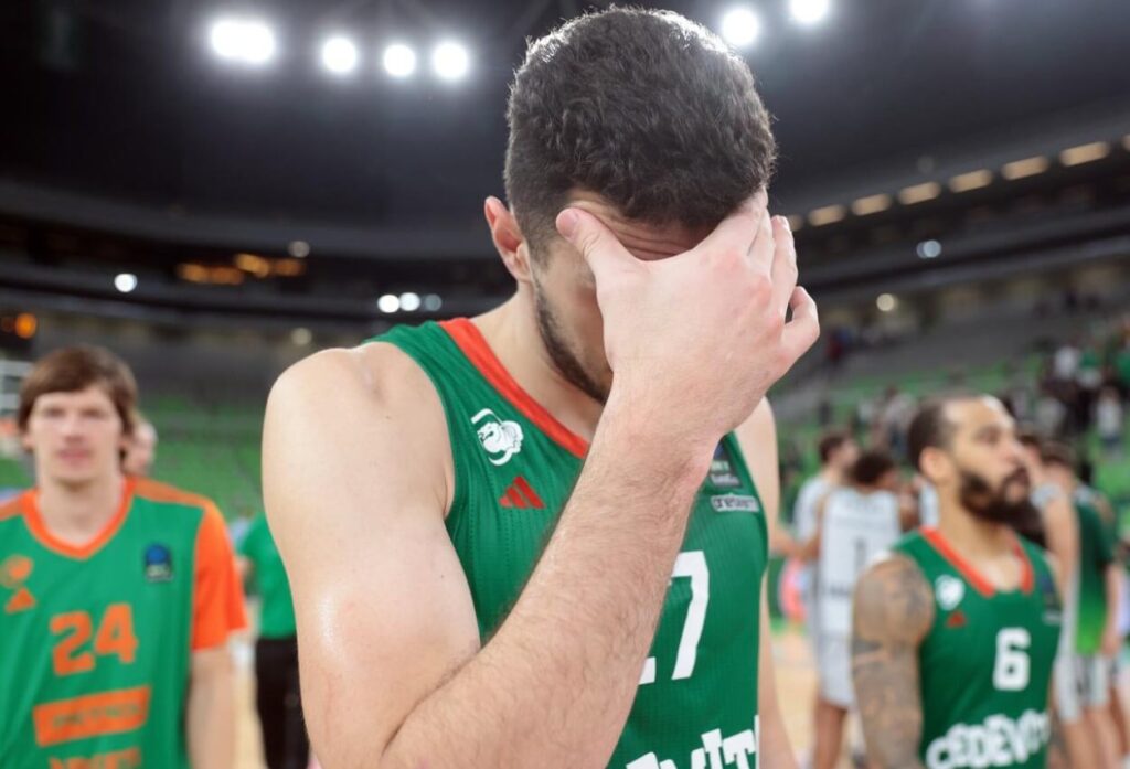 Cedevita Olimpija team experiencing the disappointment of a game lost.