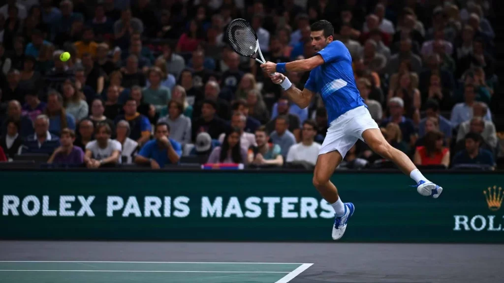 Djokovic in an intense rally during a match at the Rolex Paris Masters.