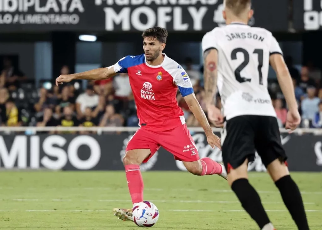 Espanyol athlete taking control of the ball in-game.
