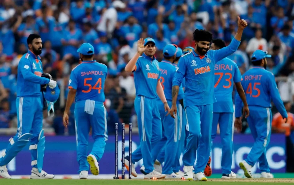 Indian cricket team players celebrating a successful play.