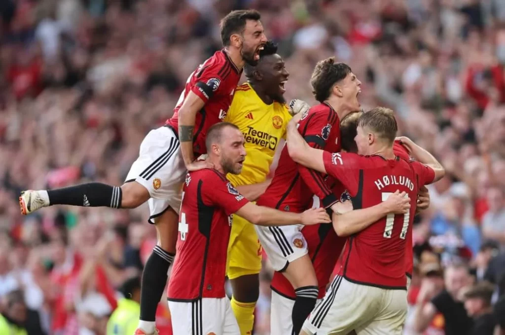 Manchester United players celebrating a winning goal.