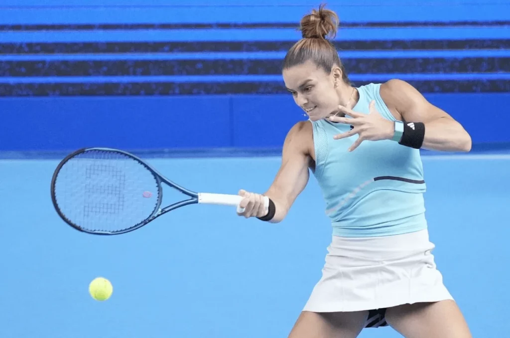 Dynamic action shot of Maria Sakkari playing tennis.
