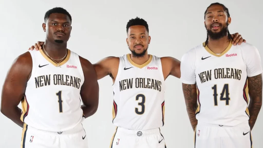 Pelicans teammates in uniform, ready to execute a play.