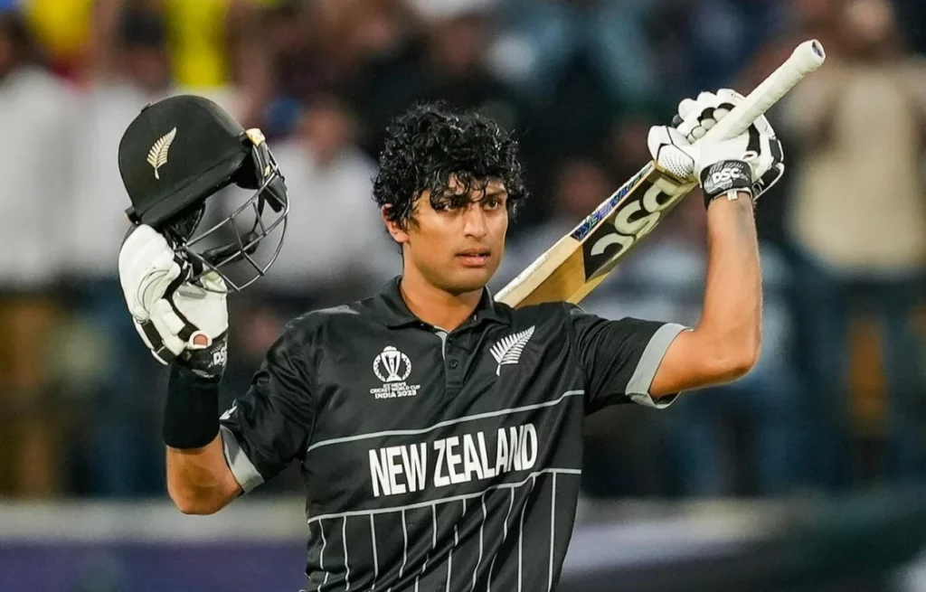 Rachin Ravindra of New Zealand jubilantly marks his 100 runs versus Australia.