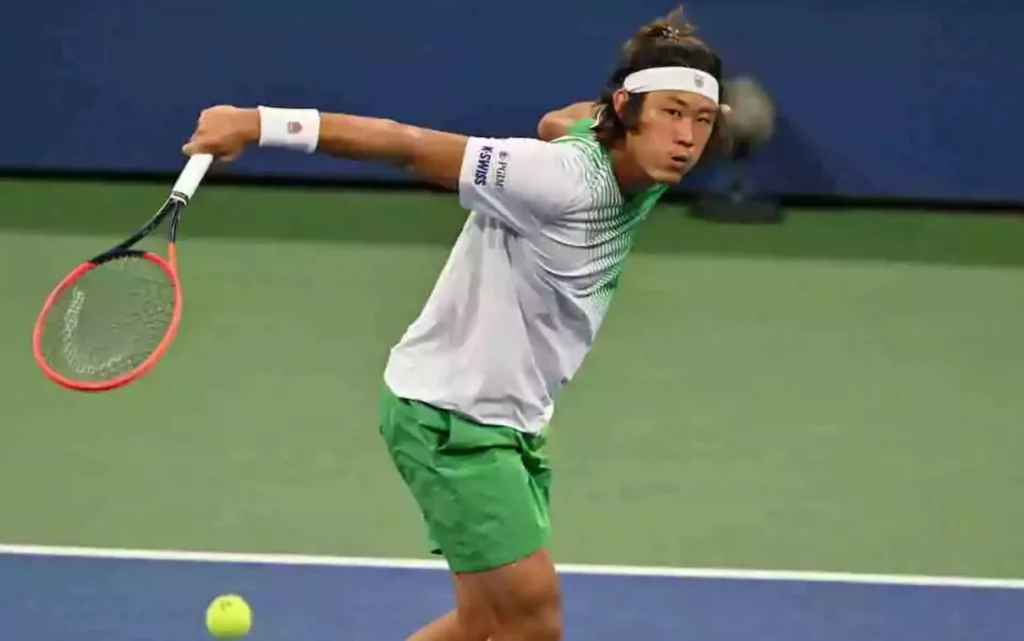 Zhizhen Zhang in action during a tennis match.