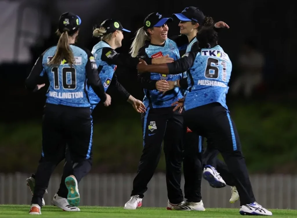Joyful Adelaide Strikers Women cricketers after a triumphant moment.