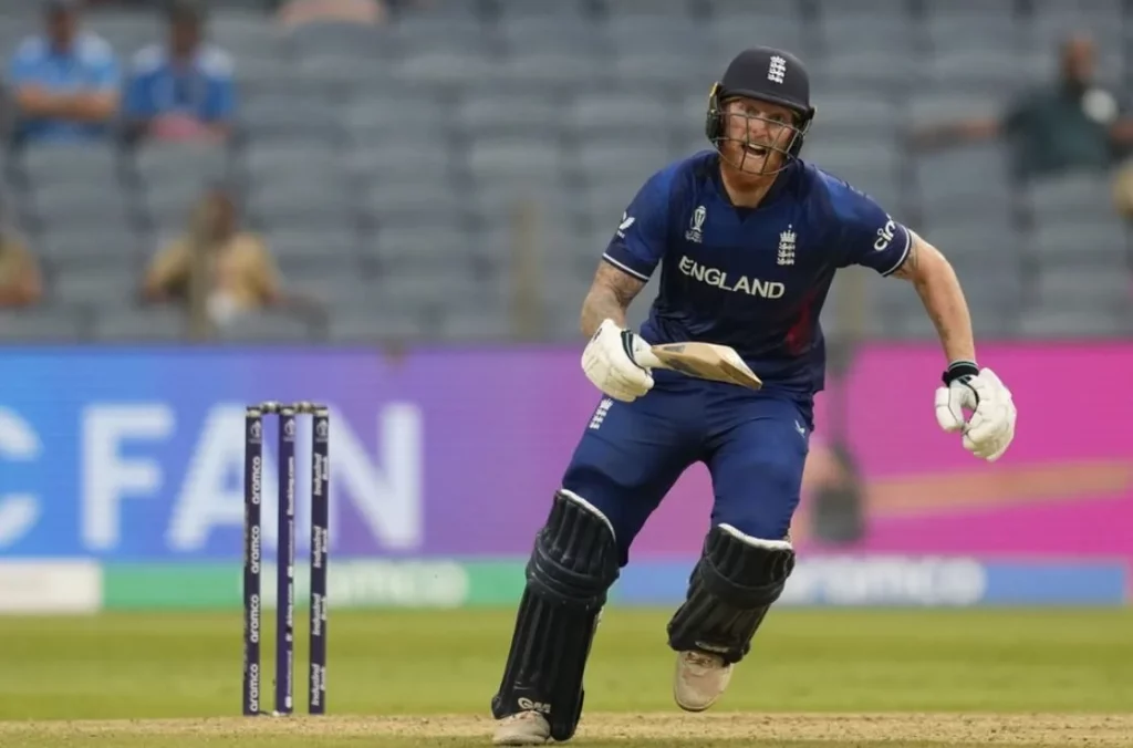 Ben Stokes in action, playing a drive on the cricket field.