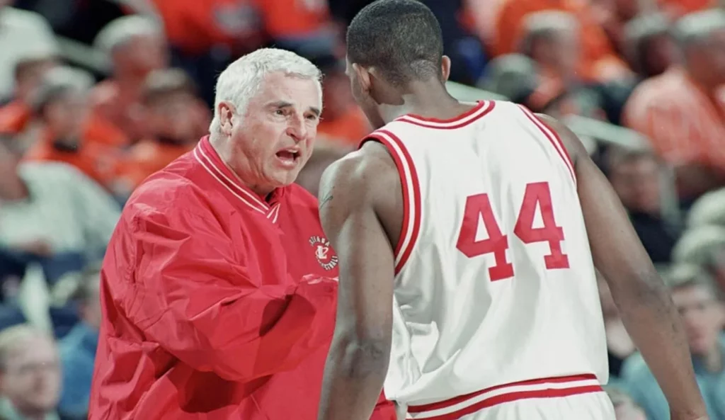 Coach Bob Knight intensely discussing strategy with his team.