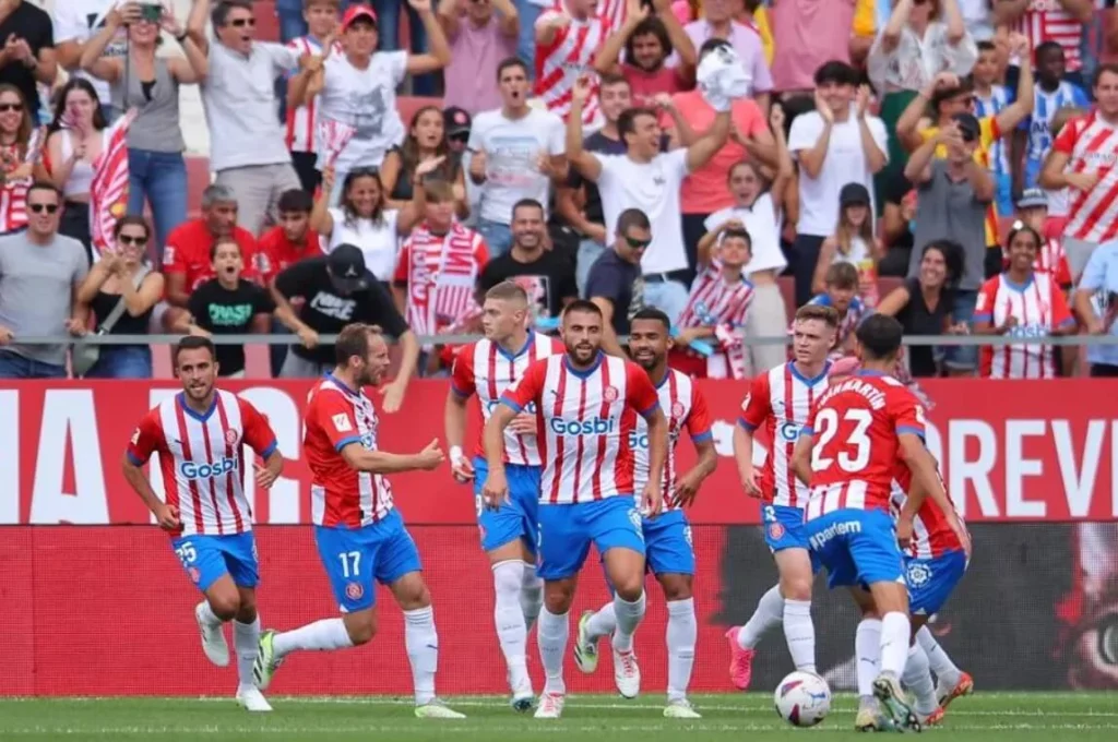 Celebrating Girona's Goal: Players in Jubilation.