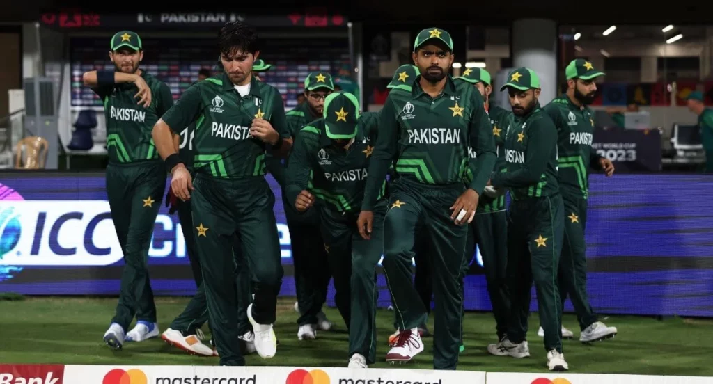Cricket players from Pakistan's team walking out onto the pitch.
