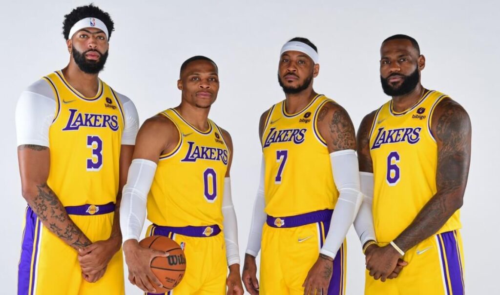 Star Los Angeles Lakers players posing together in their uniforms.