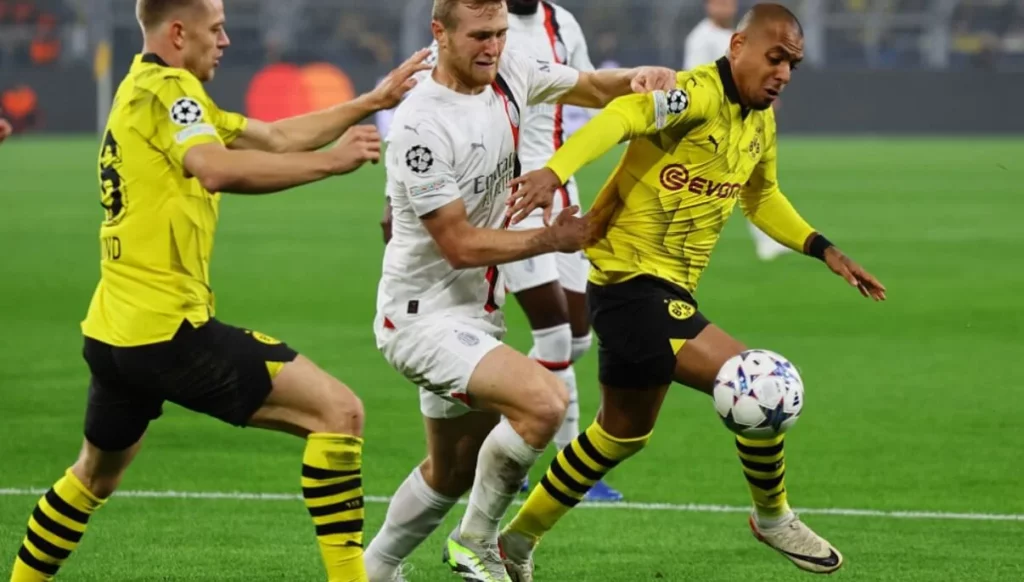 Intense moment from Milan vs Dortmund game with players competing for the ball.