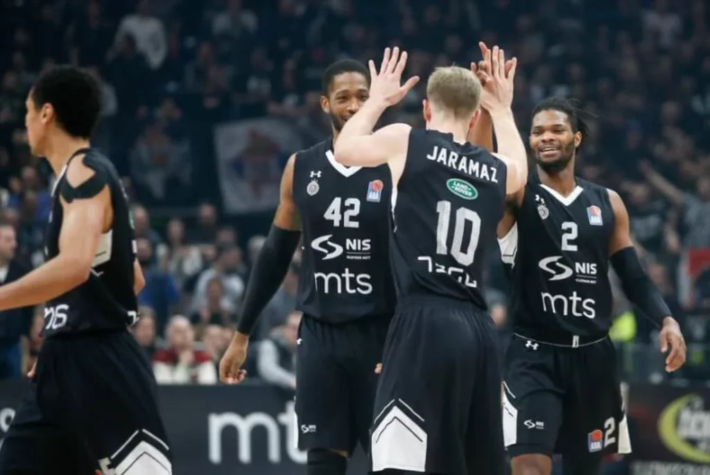 Partizan basketball players in action during a game.