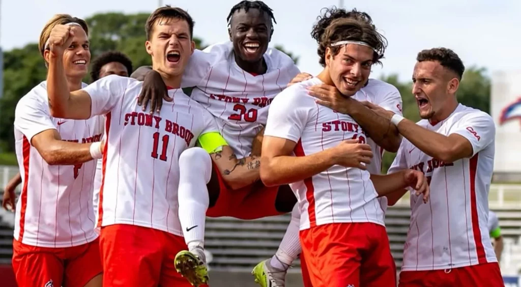 Stony Brook soccer team in high spirits, cheering after a win.