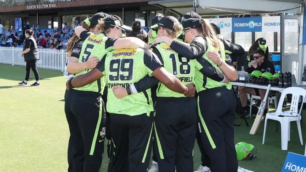 Sydney Thunder Women players in focused pre-game huddle.