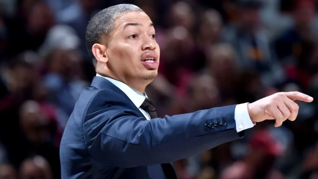 Coach Ty Lue actively giving directions to his team from the sidelines.