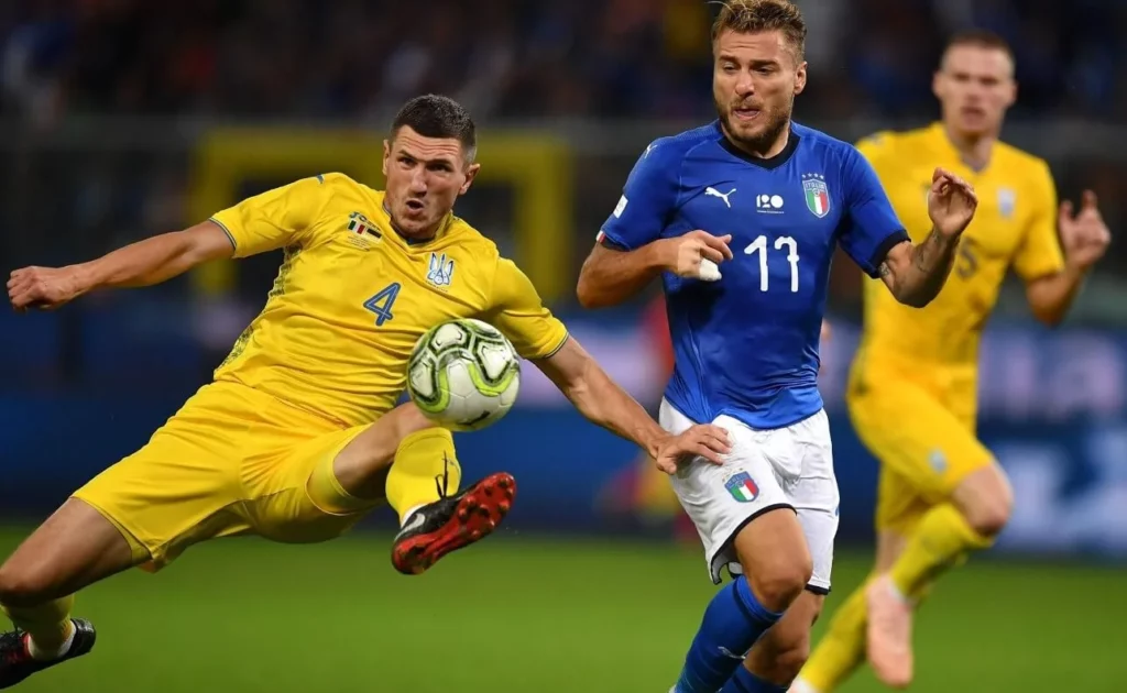 Players from Ukraine and Italy fiercely contesting possession during the game.