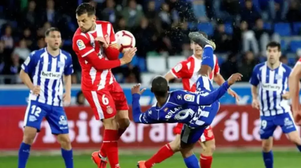 Intense moment from the Girona vs Alavés LaLiga match showing a challenging play.
