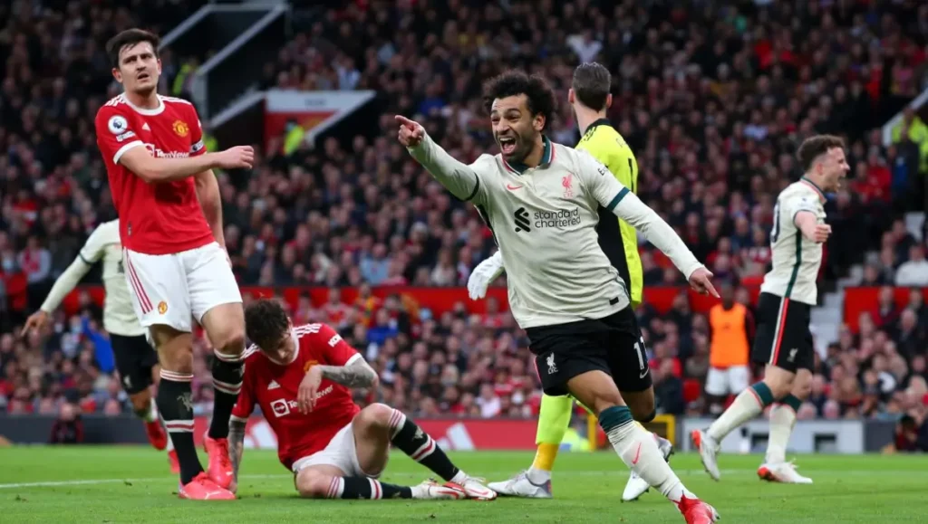 Mohamed Salah celebrating after scoring a goal against Manchester United.