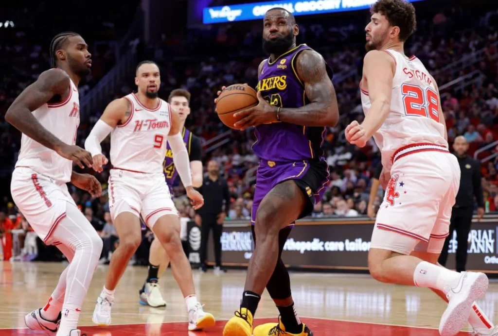 Dynamic play captured in the Lakers versus Rockets basketball showdown.
